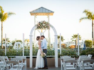 Couple kisses under beautiful wedding arch at Avila Lighthouse Suites wedding venue