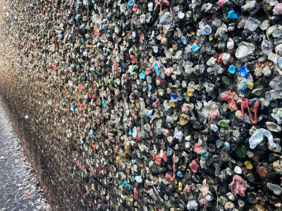A Large Crowd Of People With Bubblegum Alley In The Background